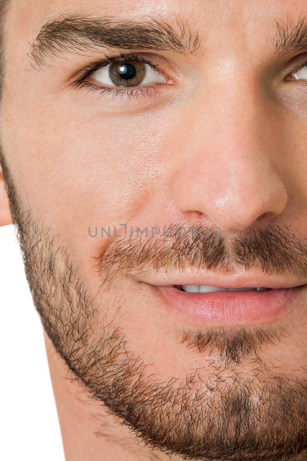 attractive muscular young man with free torso and beard isolated against white background
