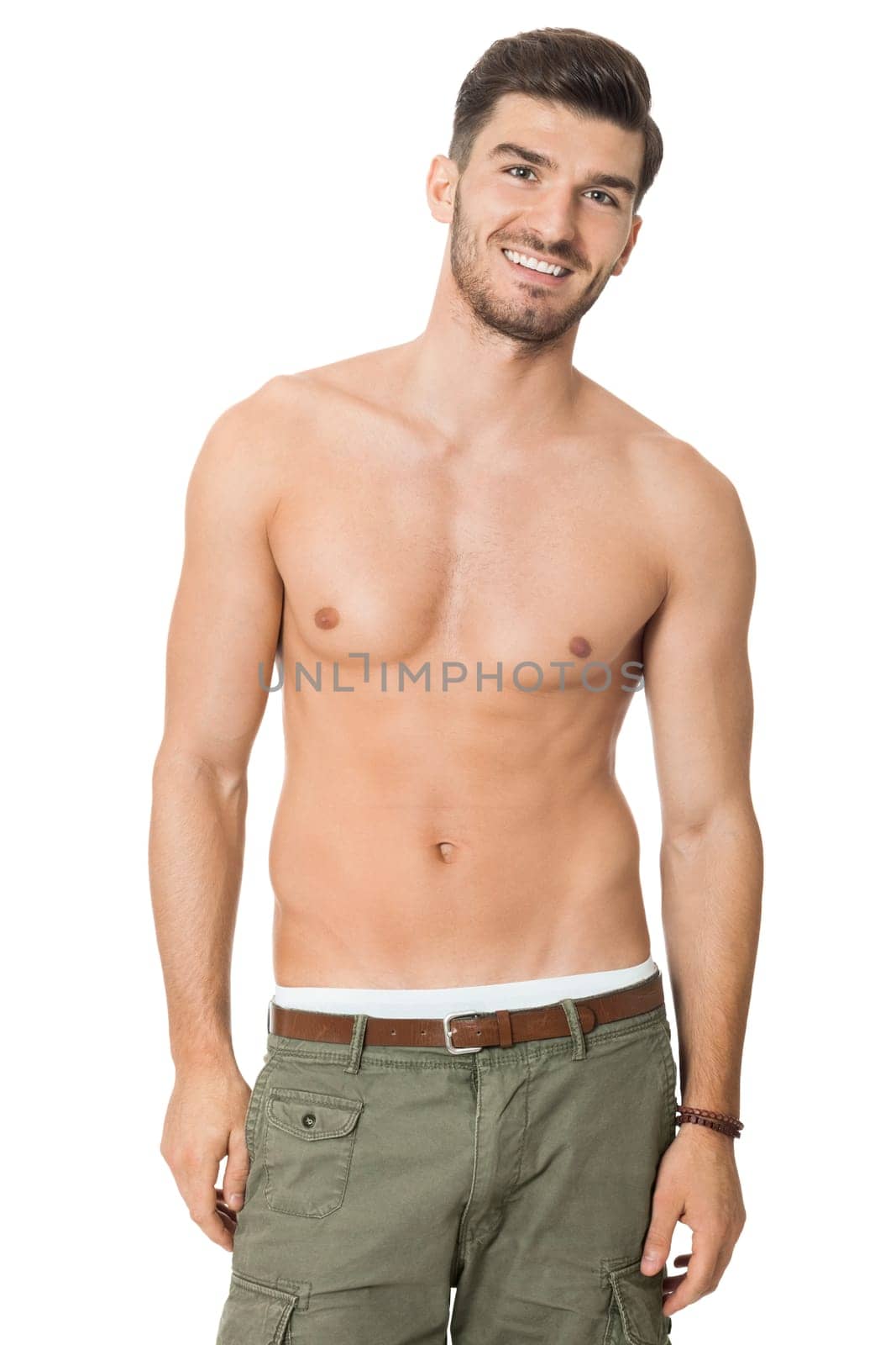 attractive muscular young man with free torso and beard isolated against white background