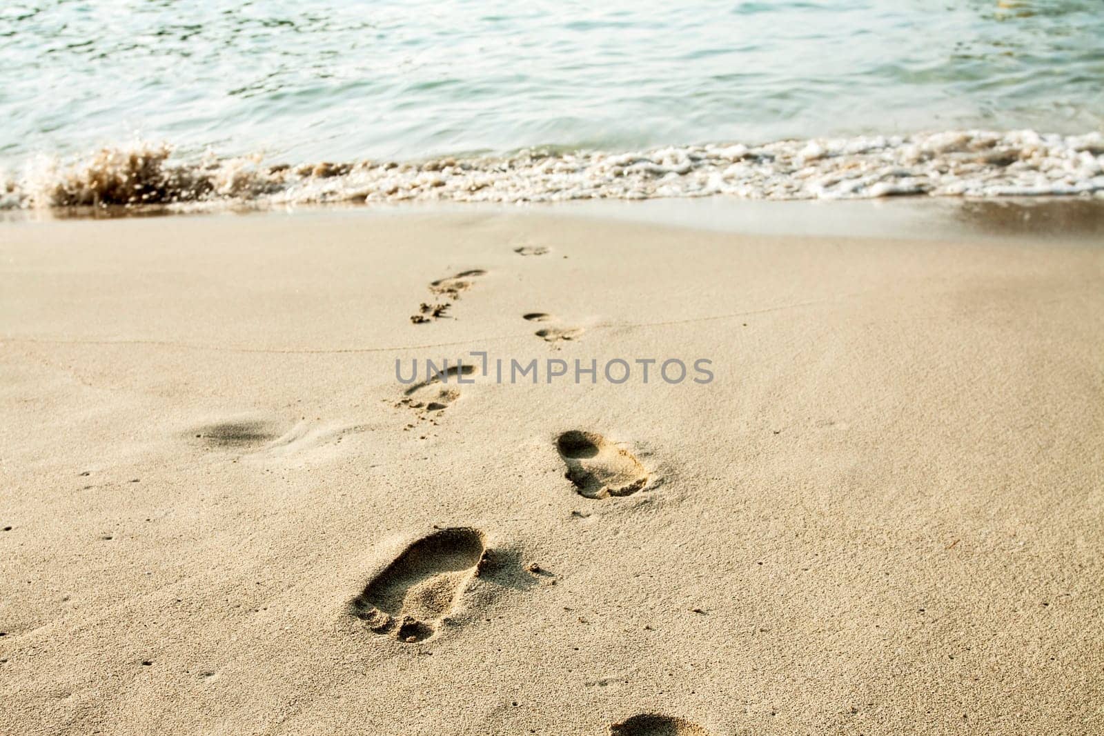 Footsteps in the sand on the beach