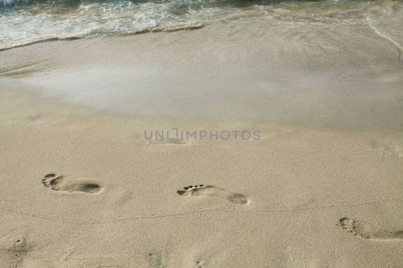 Footsteps in the sand on the beach