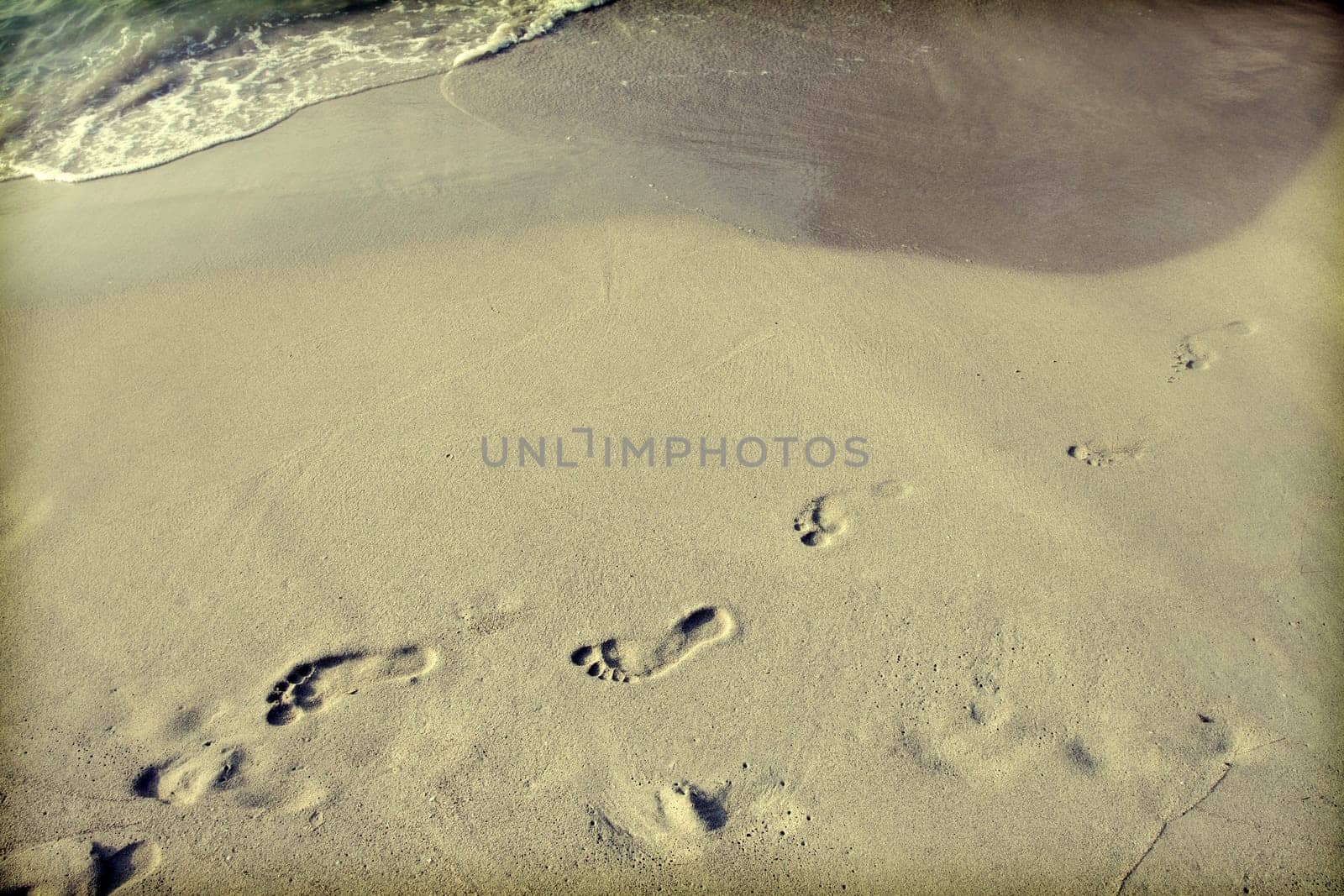 Footsteps in the sand on the beach