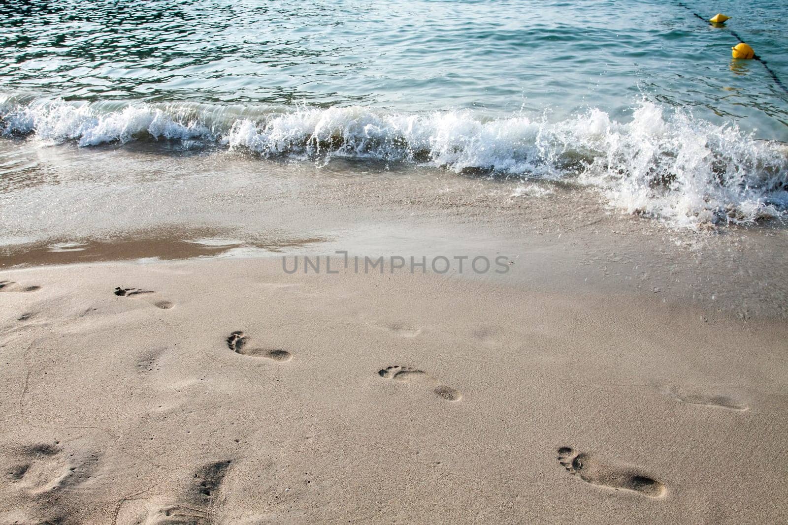 Footsteps in the sand on the beach
