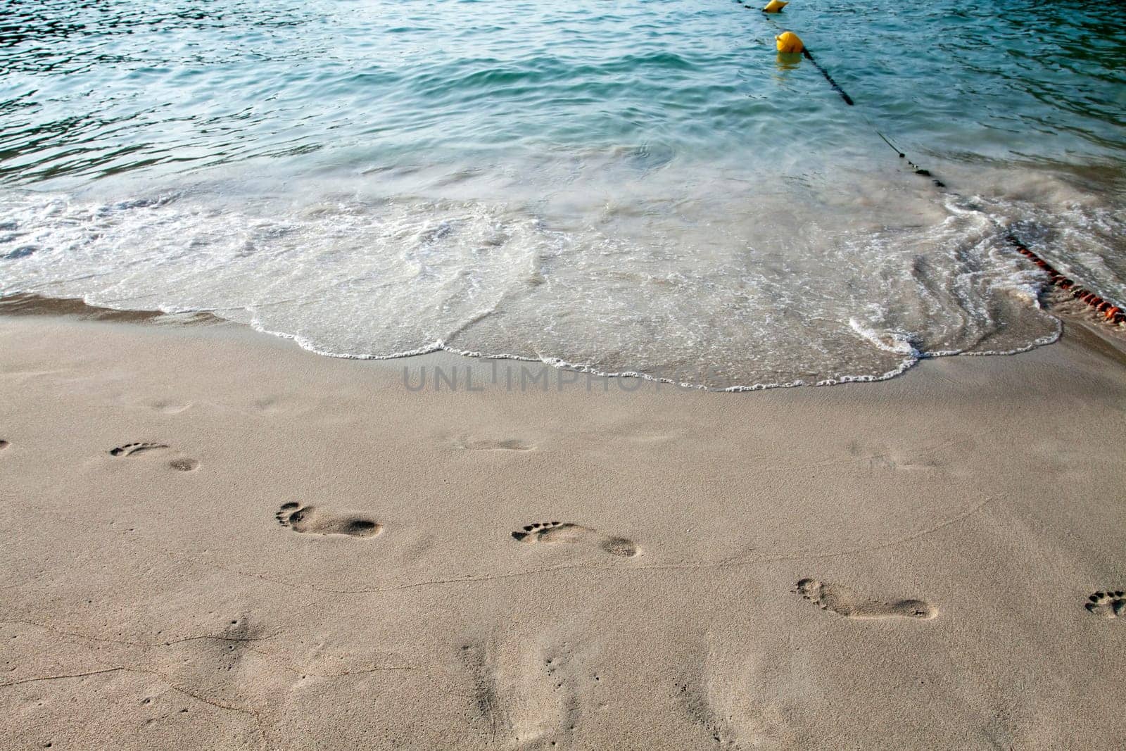 Footsteps in the sand on the beach