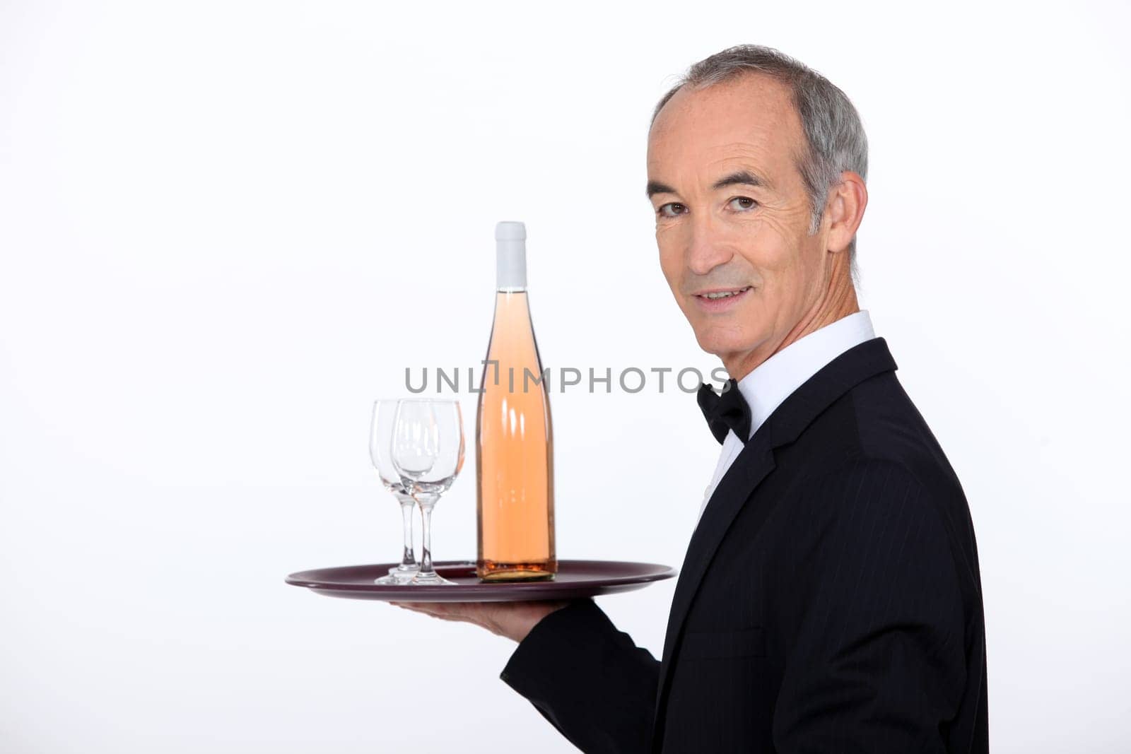 Waiter carrying wine on tray