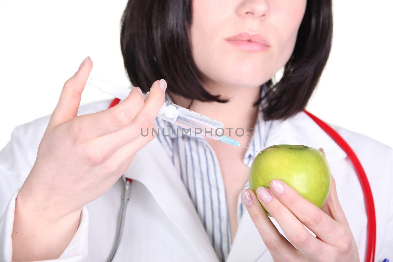 Doctor injecting hormone drugs into an apple