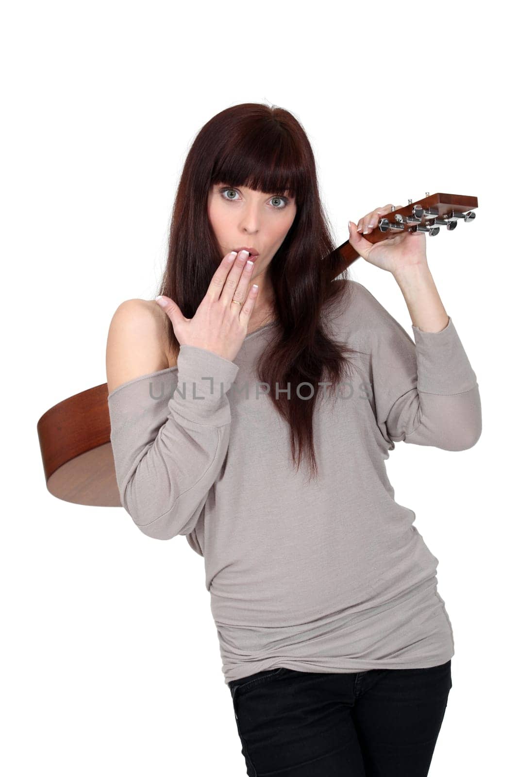 Woman stood holding acoustic guitar