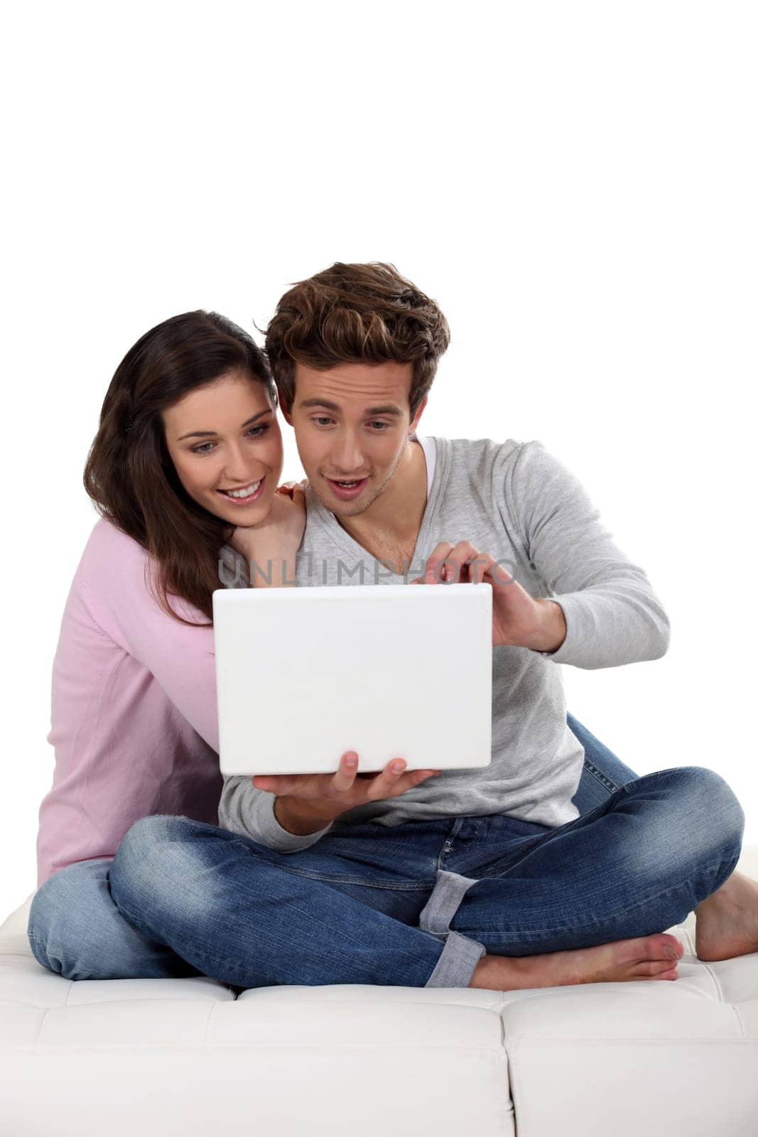 Young couple on sofa with laptop
