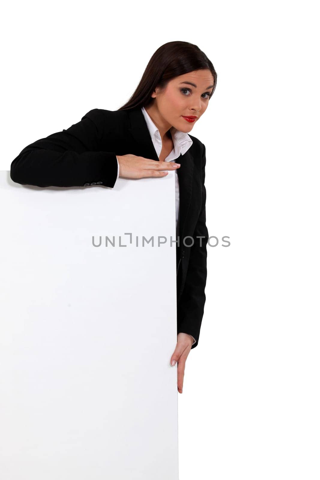 Businesswoman standing behind a white sign