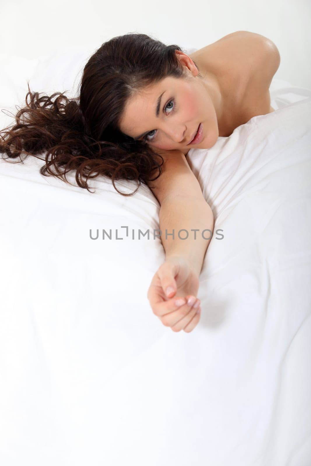 a naked woman on bed giving a hand