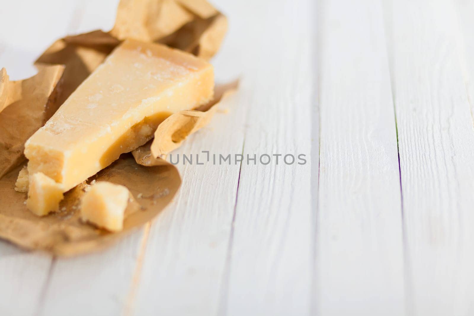 Portion of Italian parmesan cheese , or Parmigiano-Reggiano, a speciality of certain controlled Italian provinces used in traditional Italian cuisine