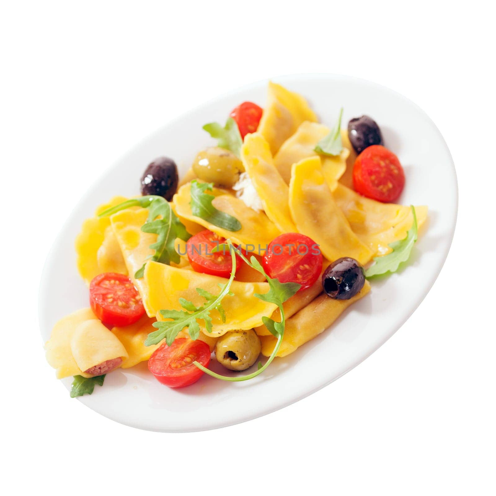 Colorful Italian ravioli salad with fresh tomatoes, rocket or arugula leaves, and black and green olives for a tasty appetizer isolated on white