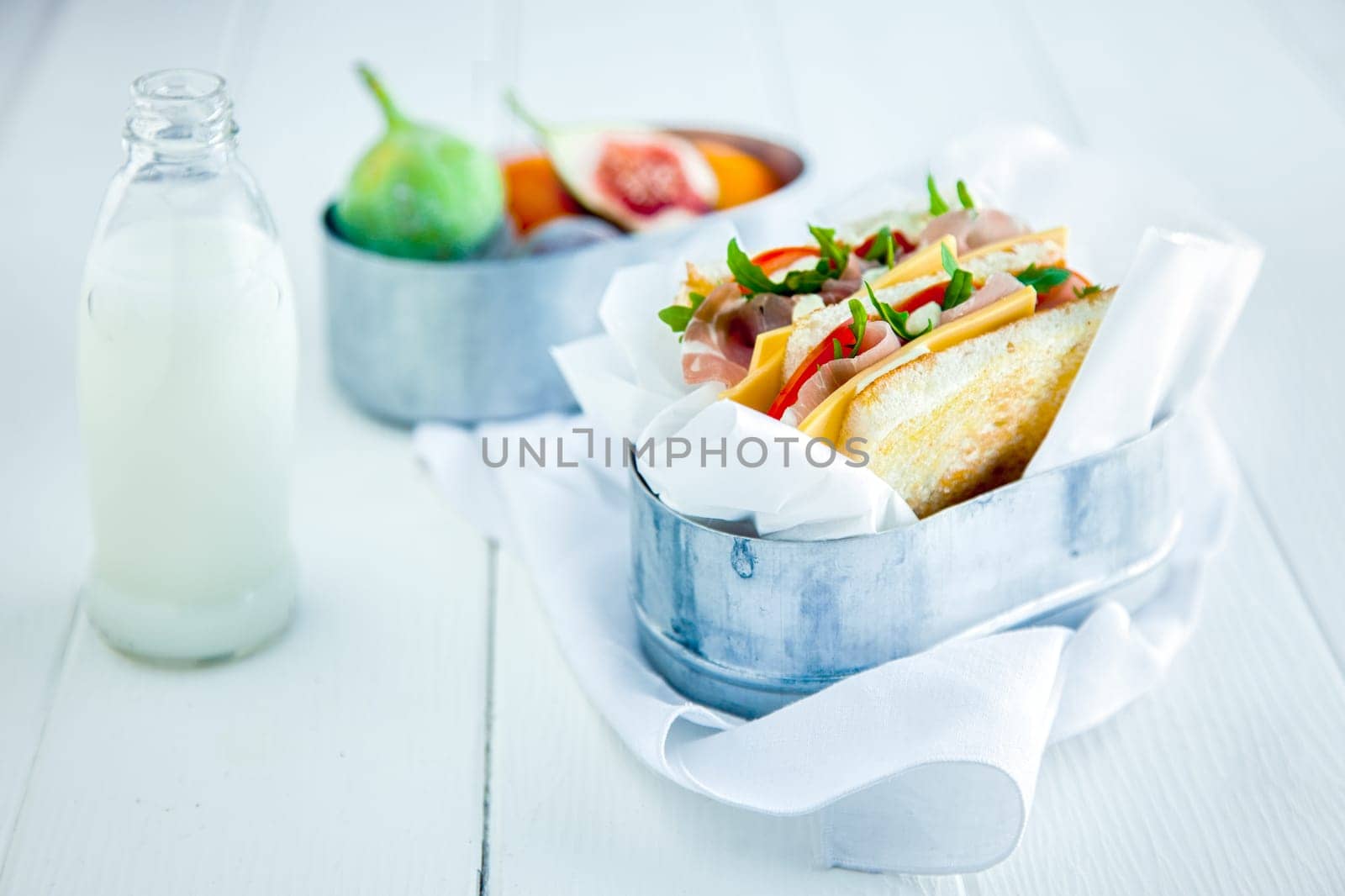 Tasty Sandwich with Fresh Milk and Fruits Served on White Wooden Table. Healthy Food for Day to Day.