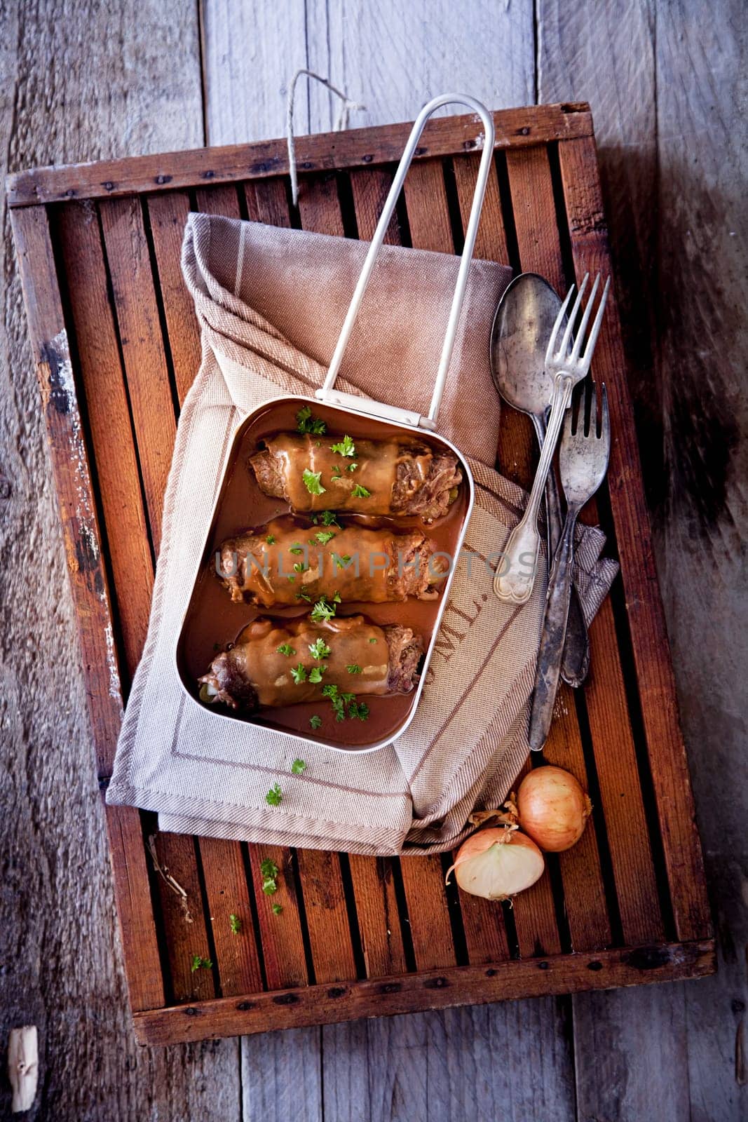 Roulades in Pan with Spoon and Fork, on Wooden Tray and Wooden Background.