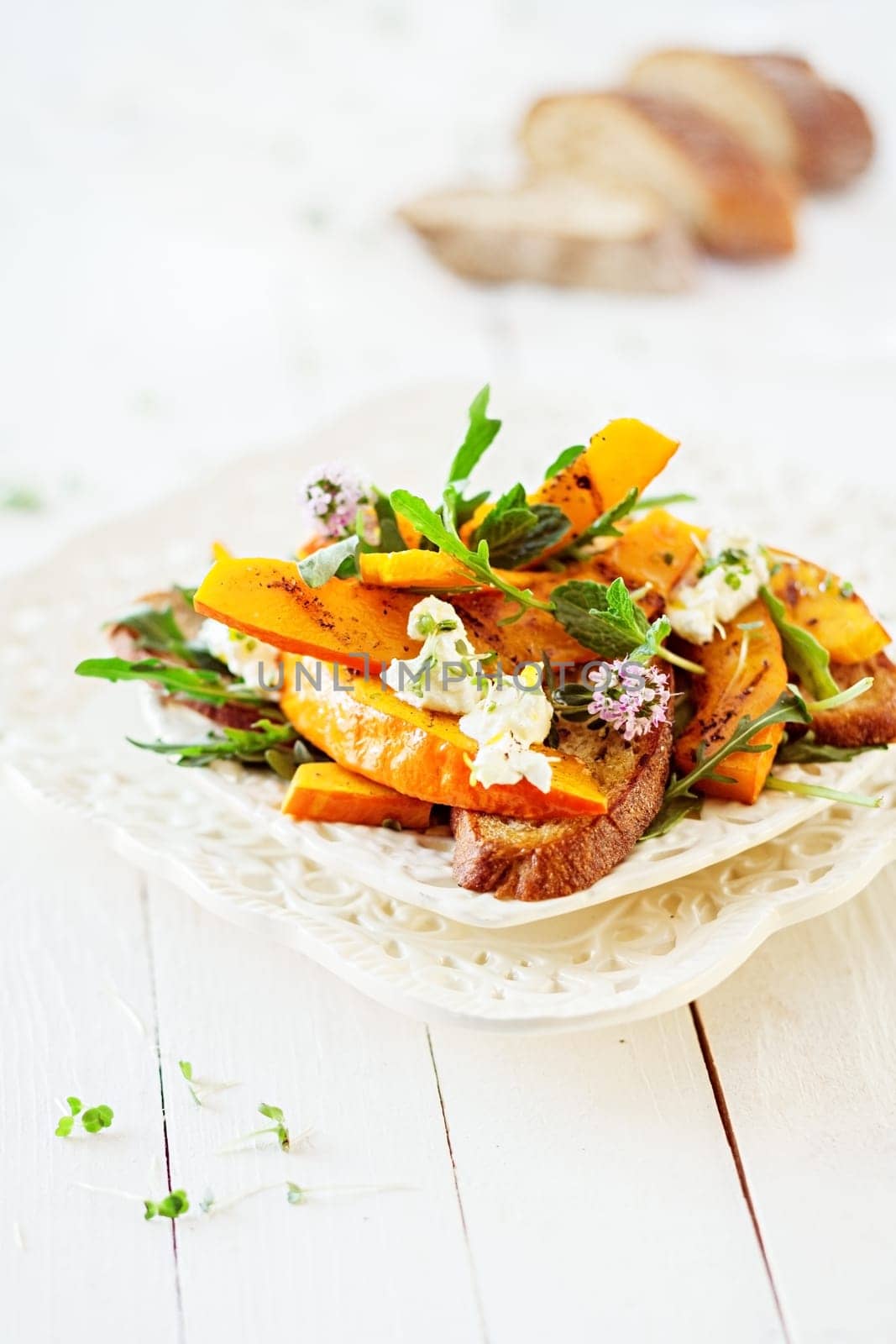 Macro Gourmet Tasty Summer Salad with Floral Style on White Wooden Table.