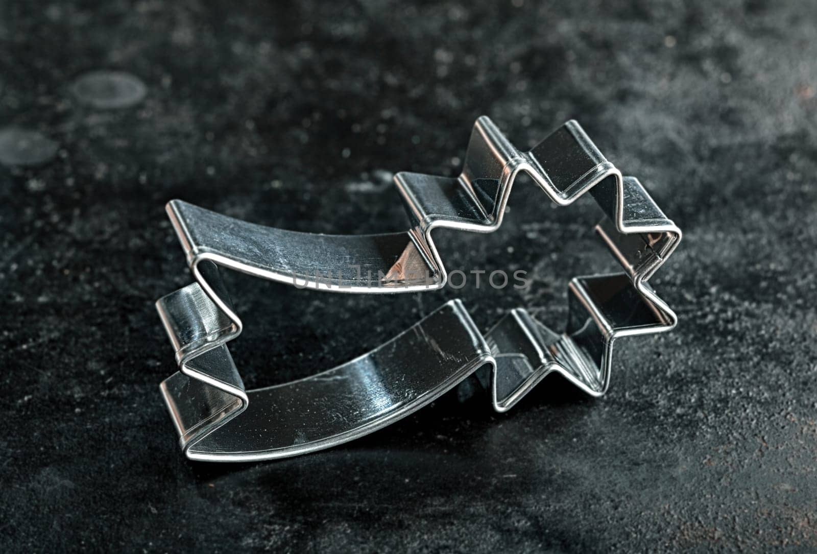 Old silver metal shooting star cookie cutter for making traditional Christmas biscuits symbolic of the Holy Star over Bethlehem at the birth of Jesus