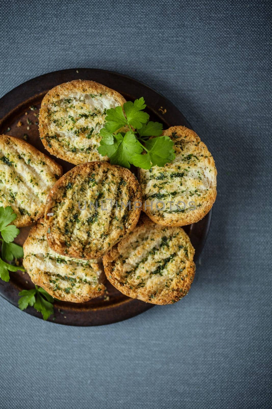 Delicious crunchy golden grilled or toasted bread seasoned with fresh herbs for a savory accompaniment or appetizer to a dinner