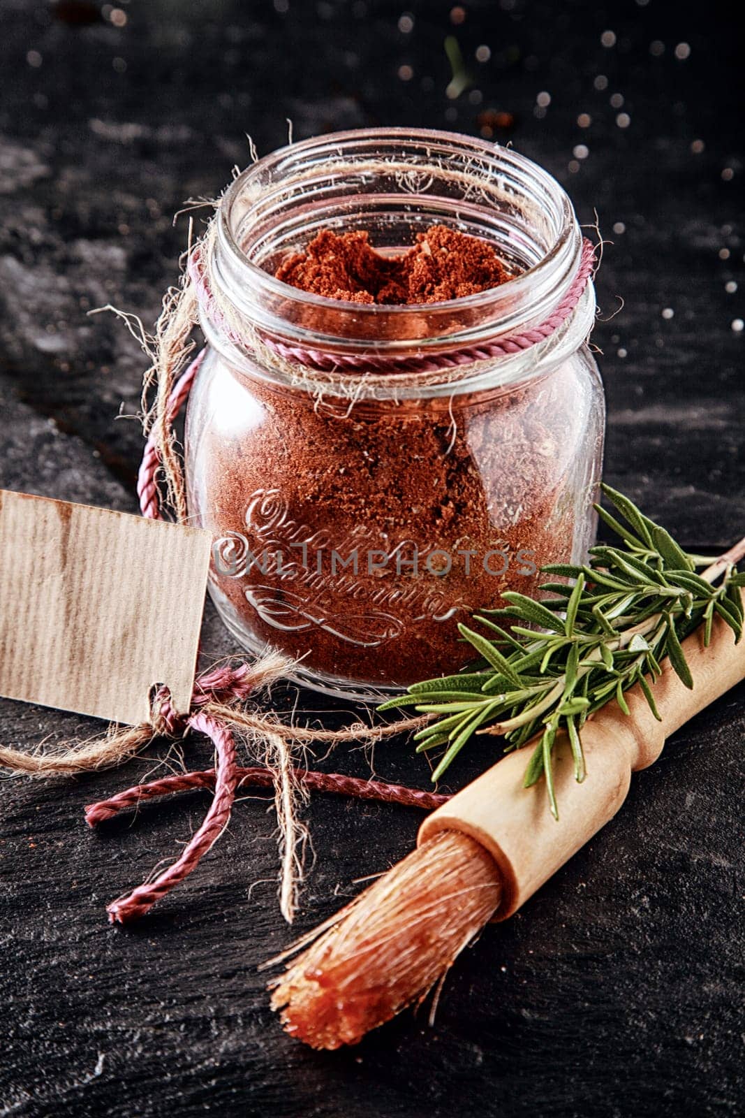 Close Up Brush and Cayenne Marinade Powder Container for Meat on Table