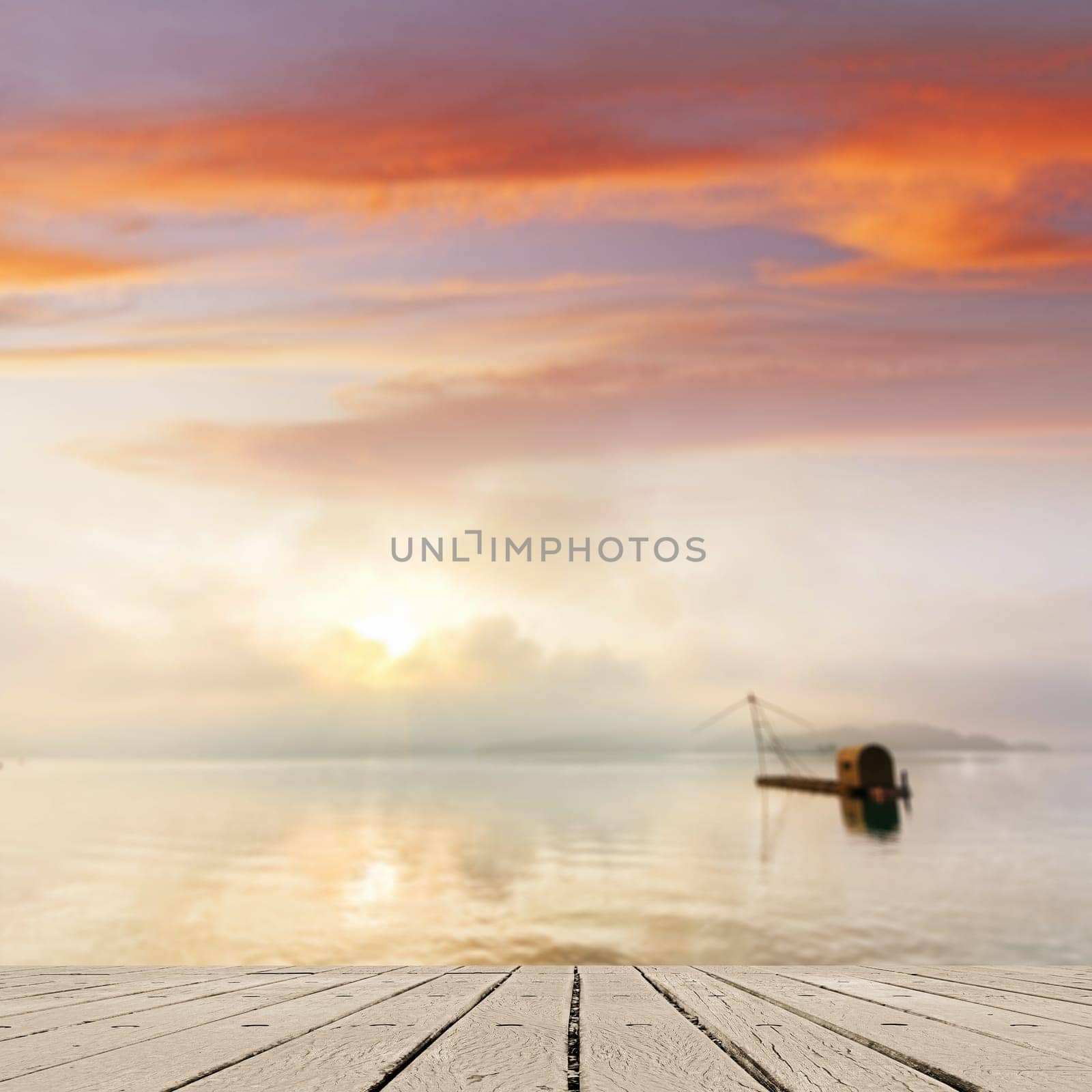 Morning concept with boat on lake with sunlight and dramatic sky, focus on wooden desk.