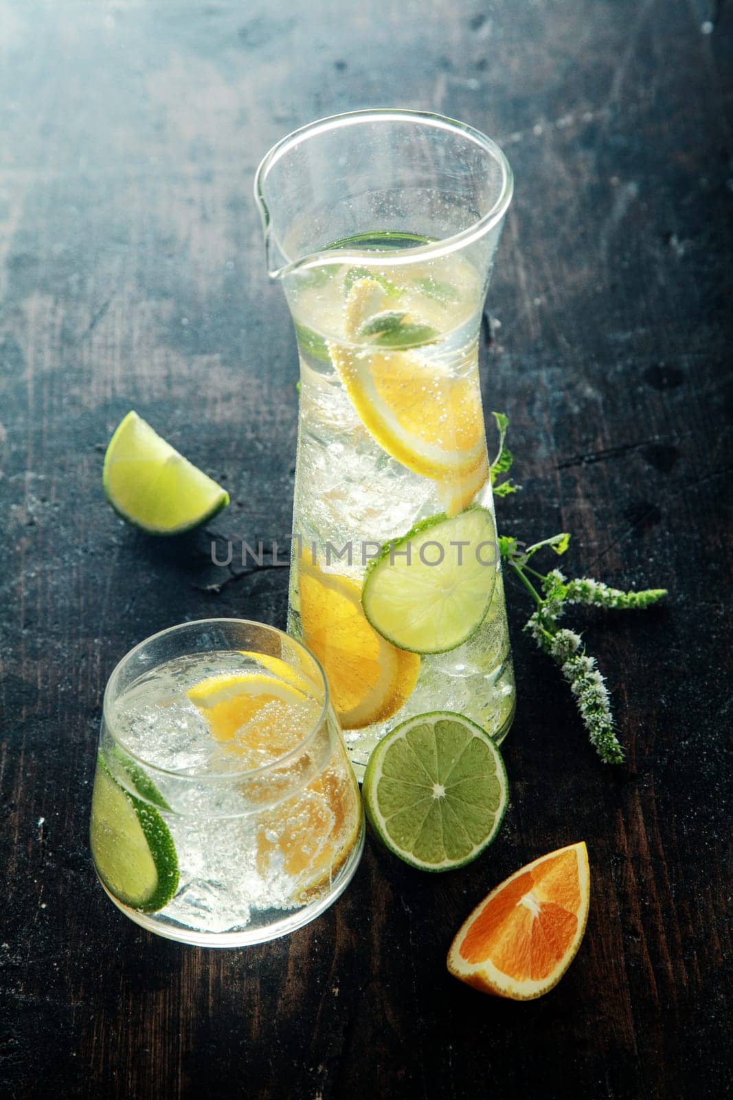 Mouthwatering Lemon Water with Fresh Lemon Inside on Wooden Table. Good Source for Vitamin C.