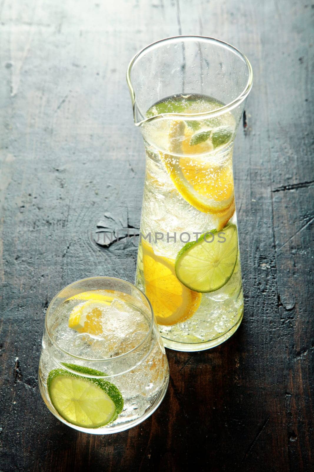 Healthy Water with Fresh Lemon Inside on Wooden Table. Good Source for Vitamin C