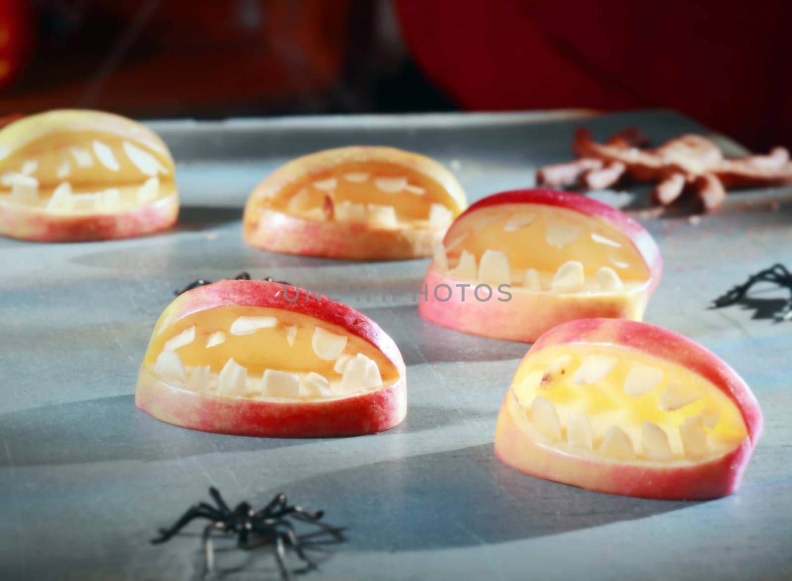 Scary Halloween decorations for trick-or-treat favors or party table decorations with gaping open apple mouths with teeth and crawling spiders in a fun homemade concept