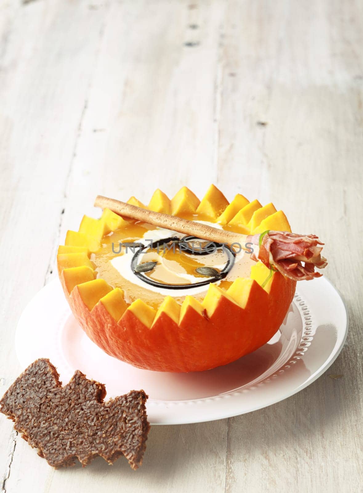 Pumpkin Soup with Bat Shaped Toast Crouton and Broomstick Bread Stick and Copyspace
