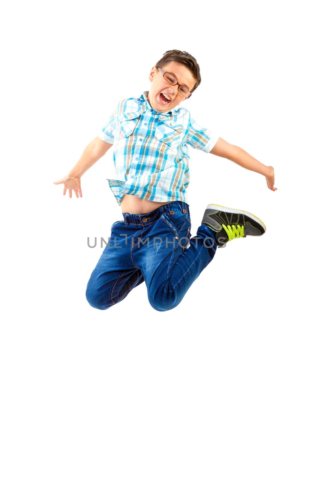 Happy little boy jumping on white background