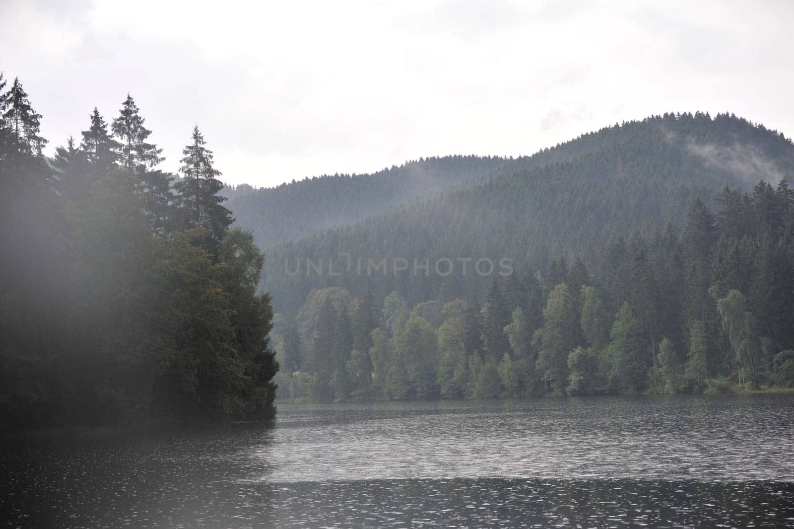 Misty landscapes in Sösestausee,middle mountains in the Harz,Germany Sunbeam through Sösestausee after the rain.