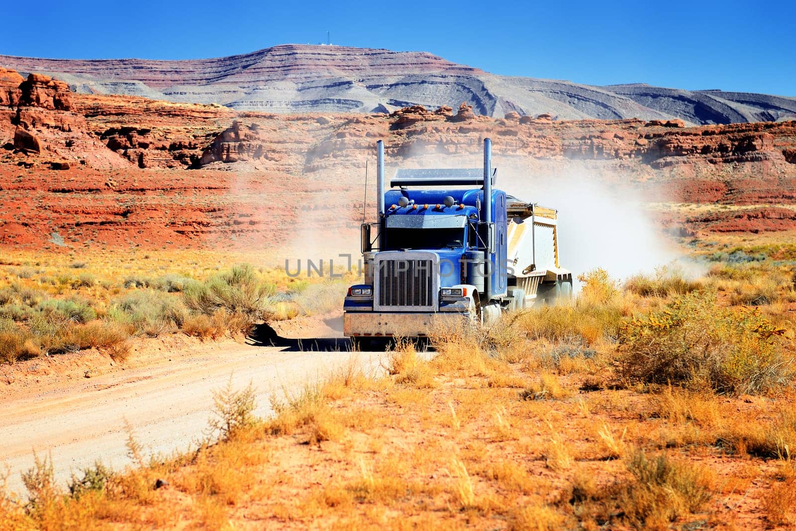 Semi-truck driving across the desert, USA