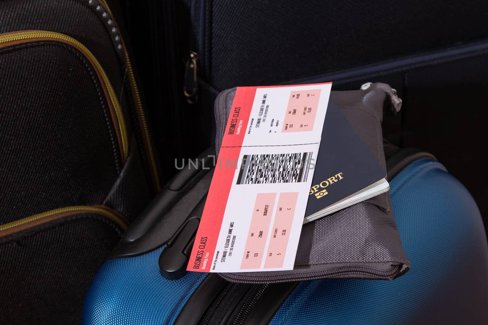 Airline ticket, passport and luggage, ready to travel.