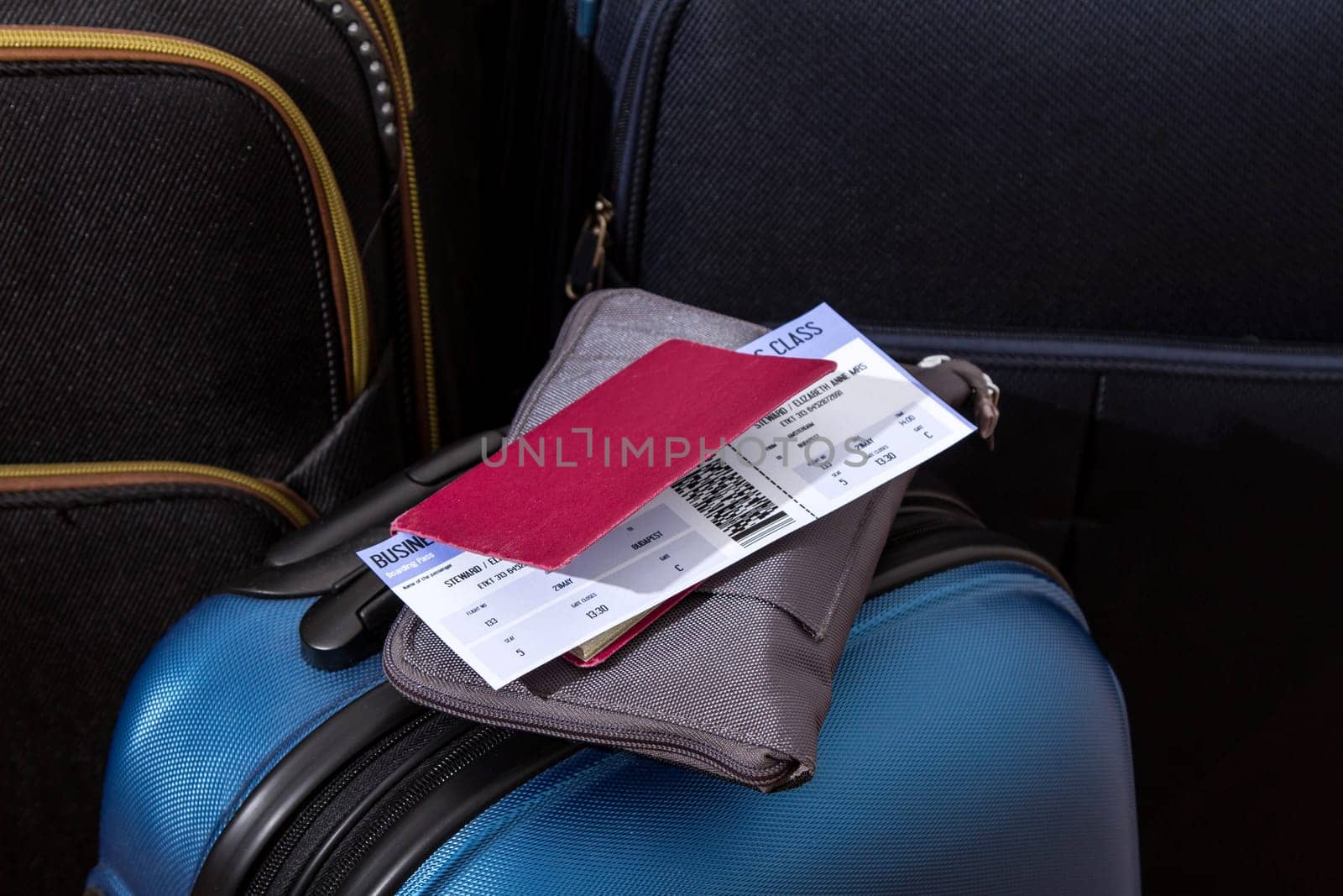 Airline ticket, passport and luggage, ready to travel.