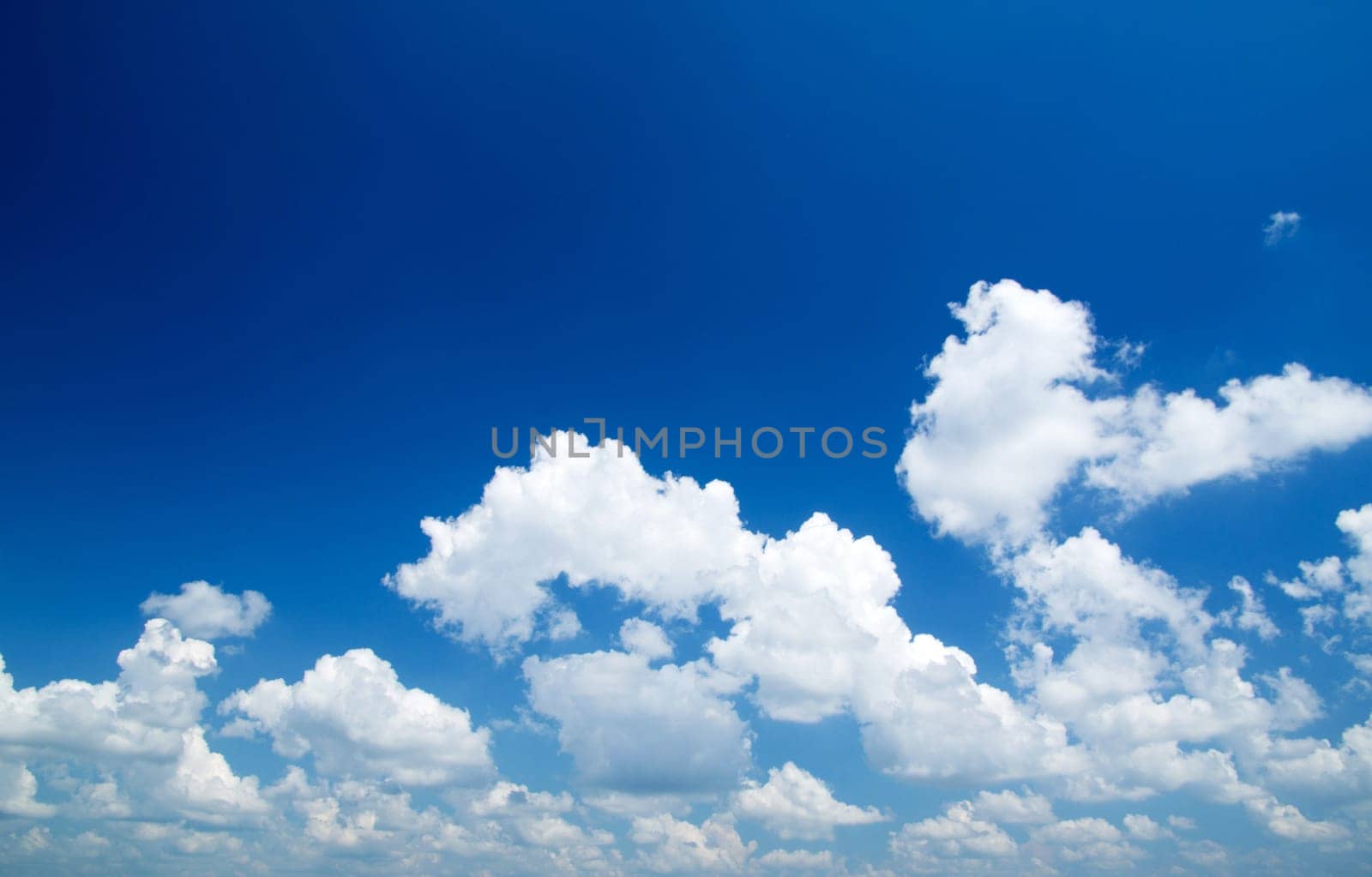 blue sky background with tiny clouds