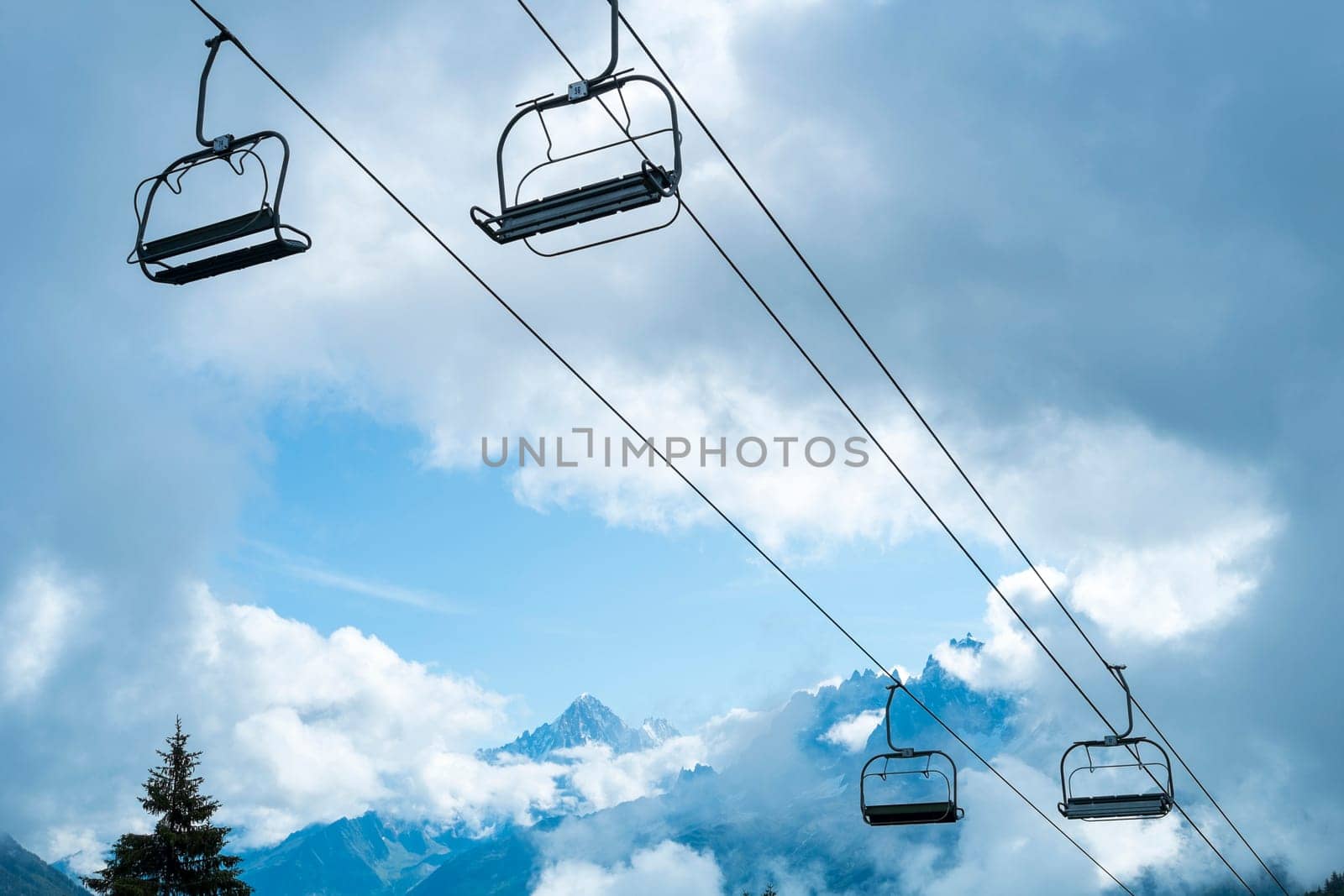 Low angle shot of alpine air lift with trees in the background
