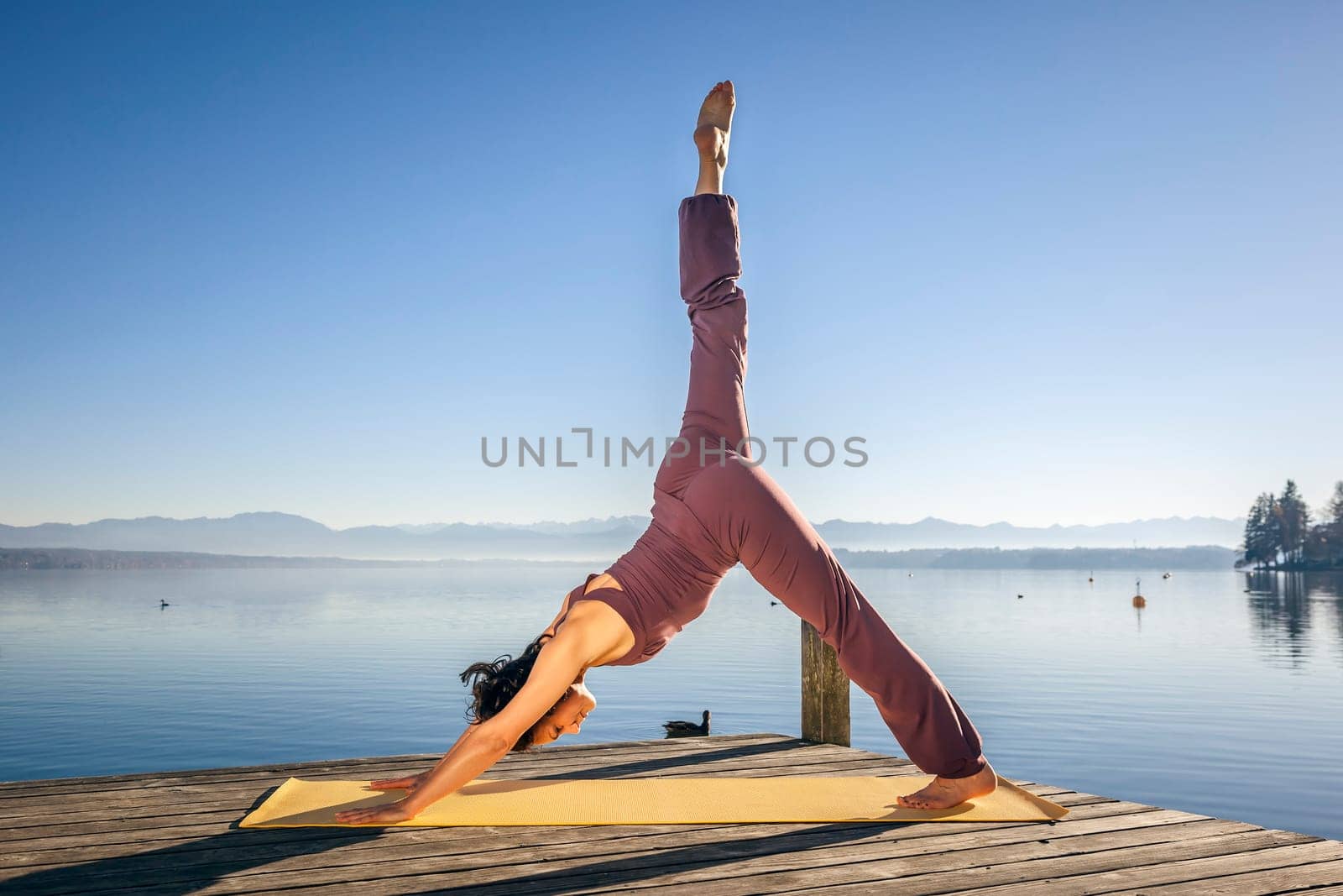 An image of a pretty woman doing yoga at the lake