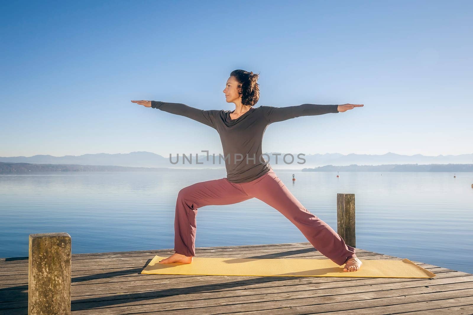 An image of a pretty woman doing yoga at the lake
