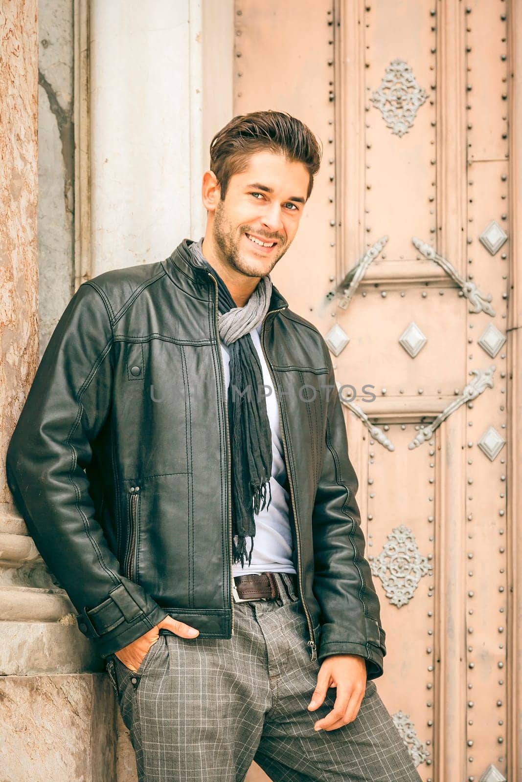 An image of a young man with a black leather jacket