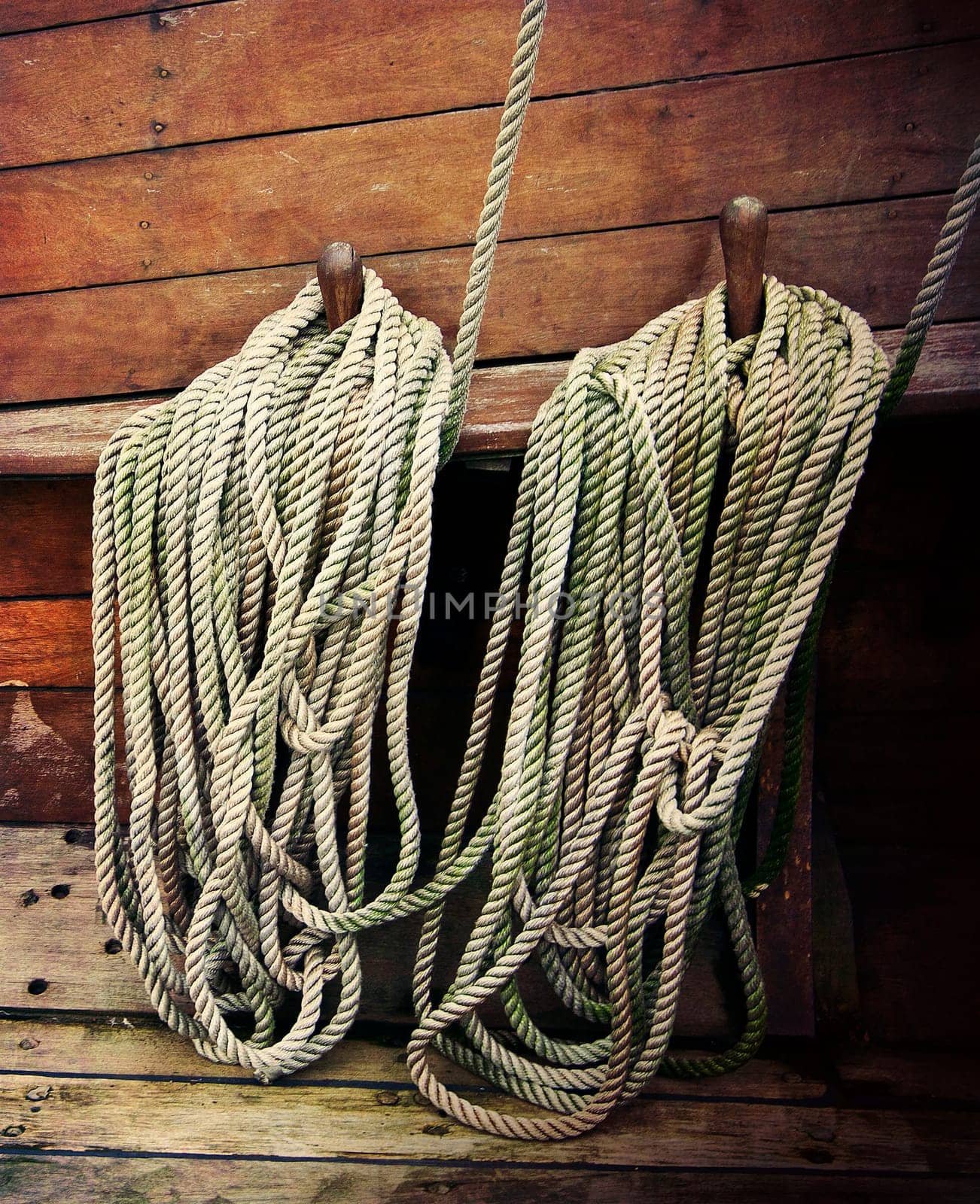 Ropes fastened around cleats on an old sailboat