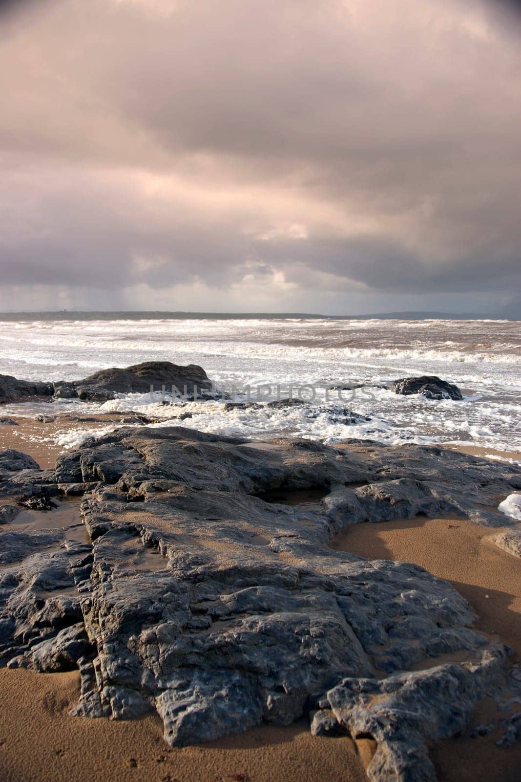 the black rocks on Ballybunion beach in county Kerry Ireland after a storm