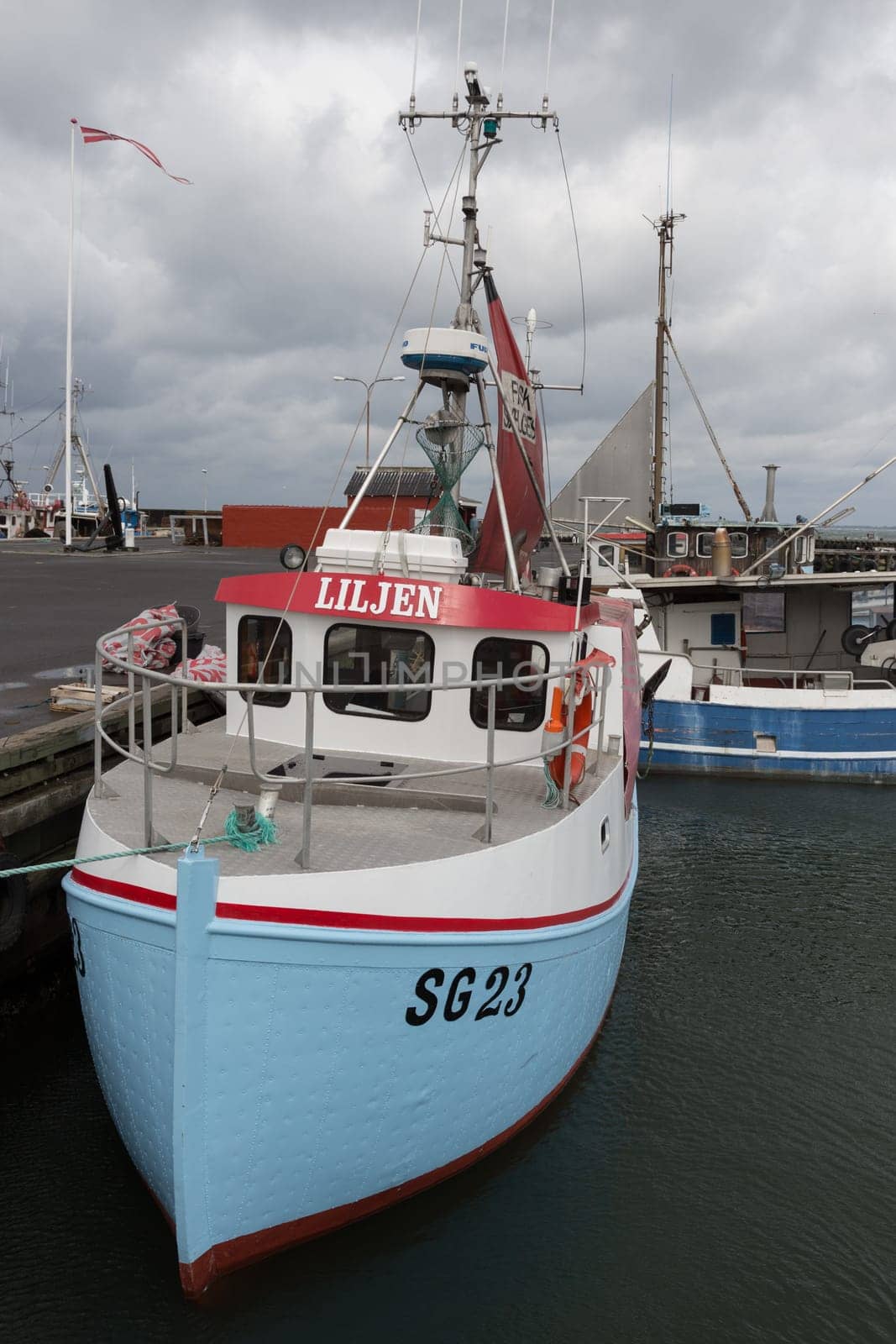 Small blue fishing boat in the port of Bagenkop