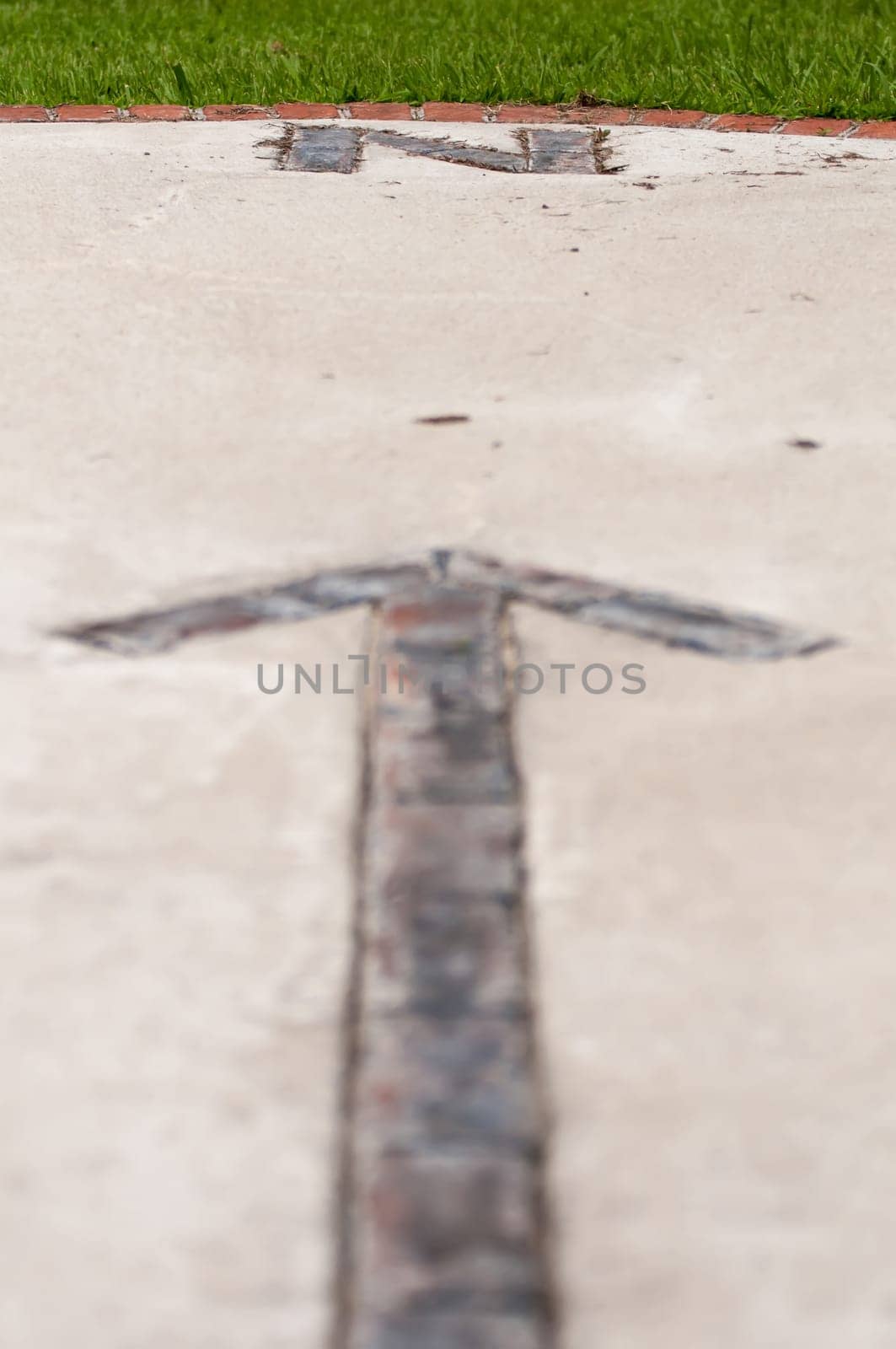 brick paver north arrow compass embedded in concrete