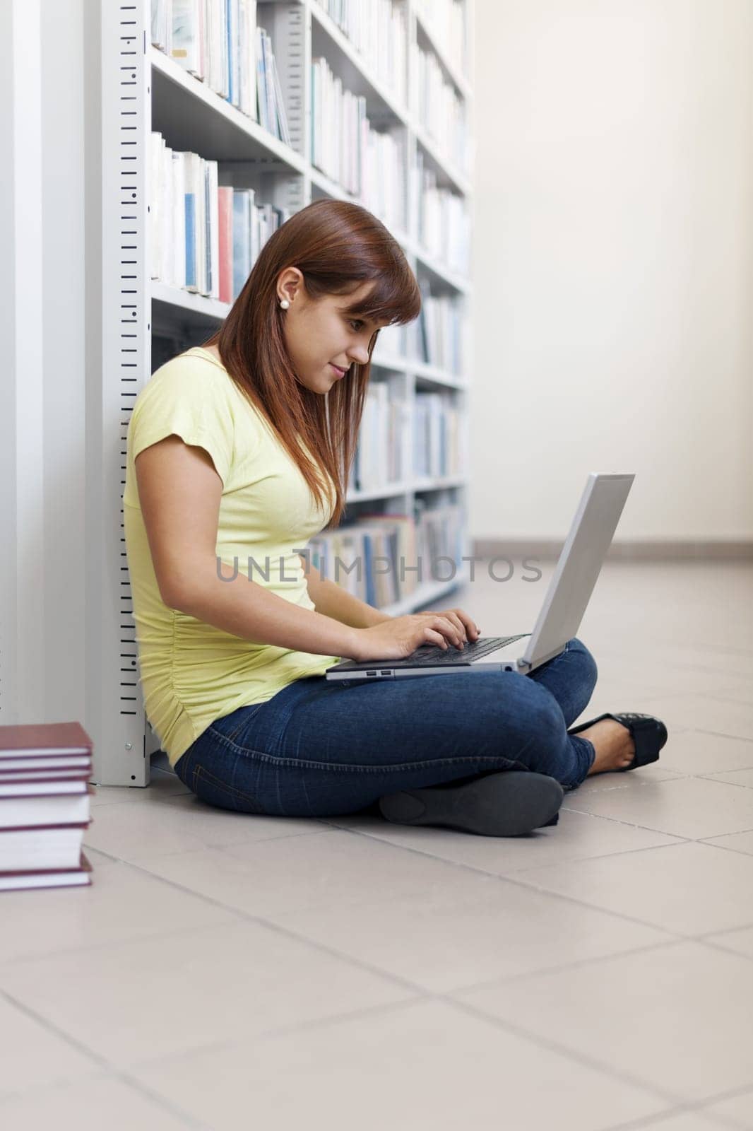 Student using laptop in library