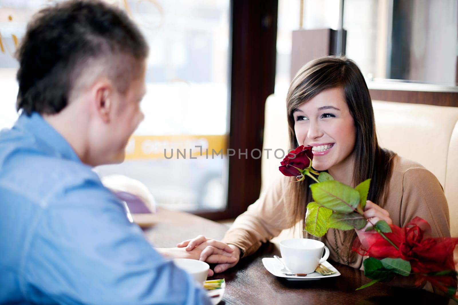 Young man giving a rose his girlfriend