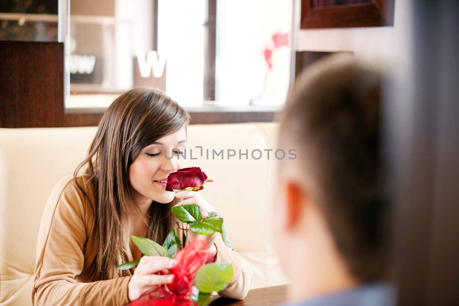 Young man giving a rose his girlfriend