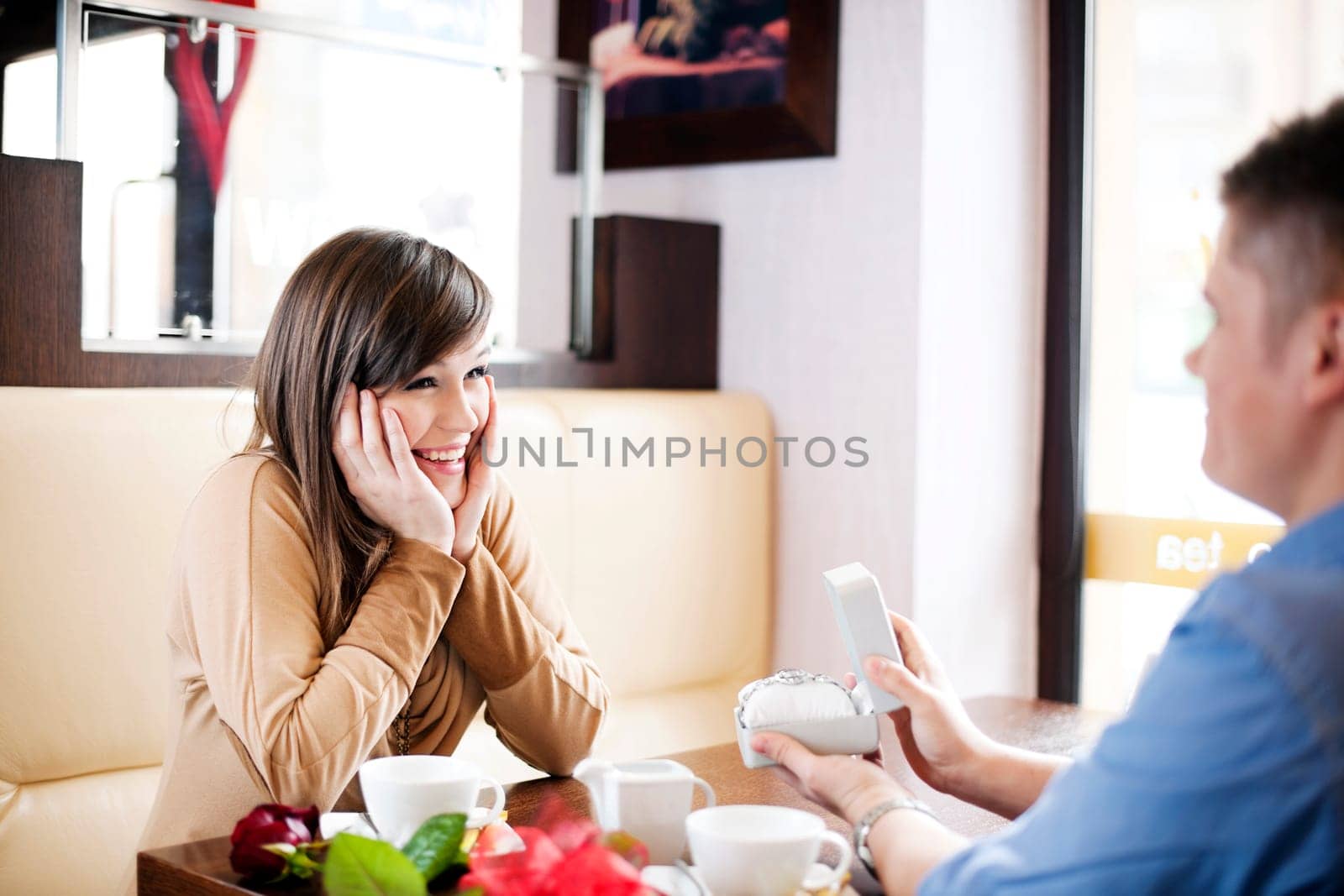 Young man giving a watch his girlfriend on Valentine's Day