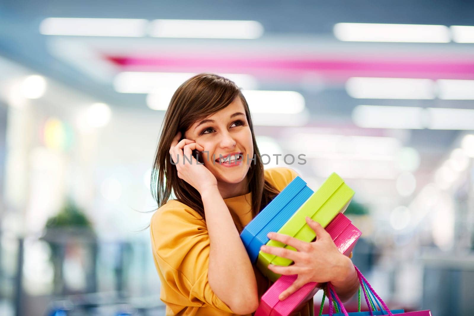 Beautiful woman on the phone in shopping mall