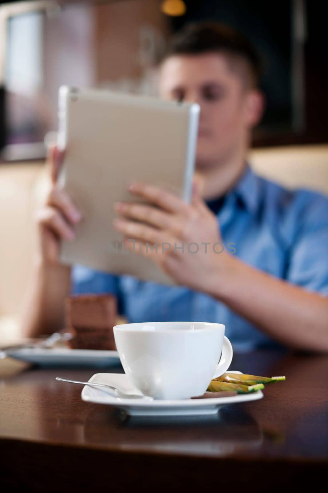 Young man using tablet in coffee shop