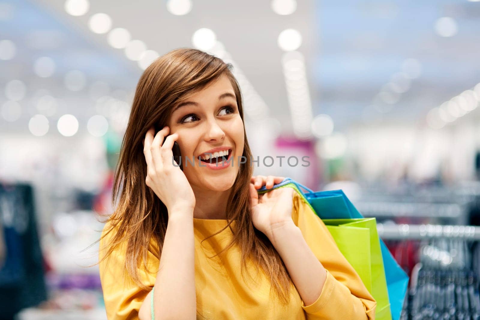 Beautiful woman on the phone in shopping mall