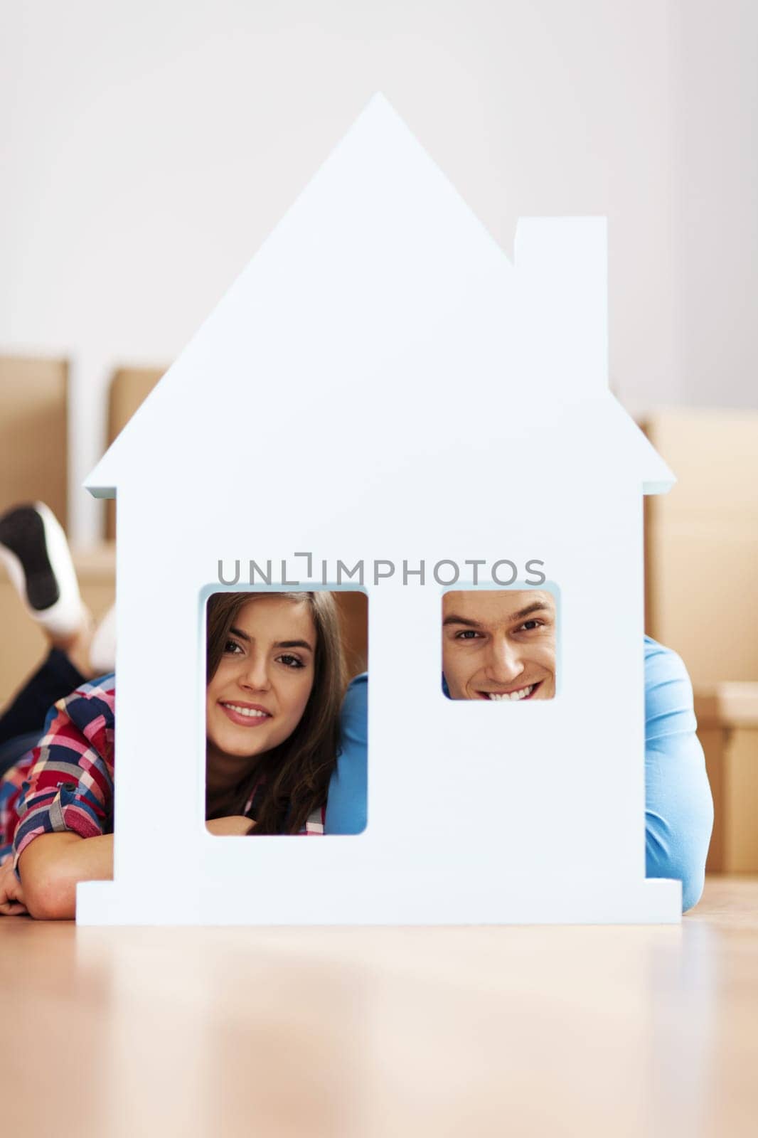 Happy couple with home sign