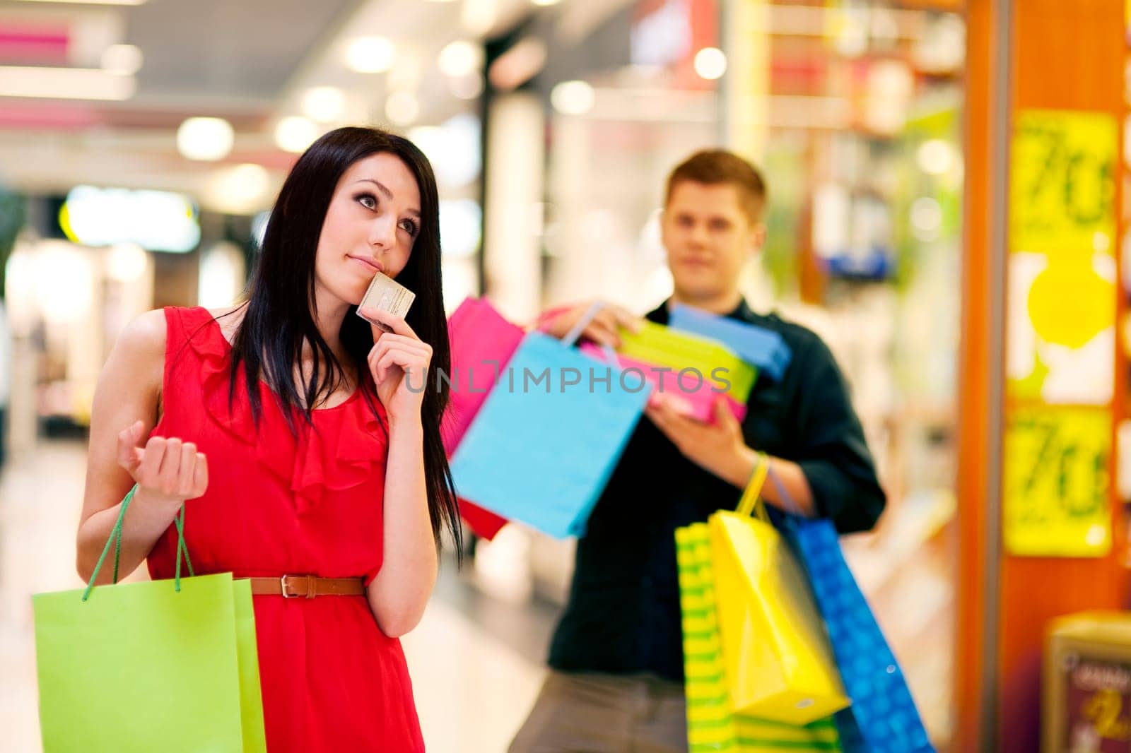 Young woman spending too much money for shopping