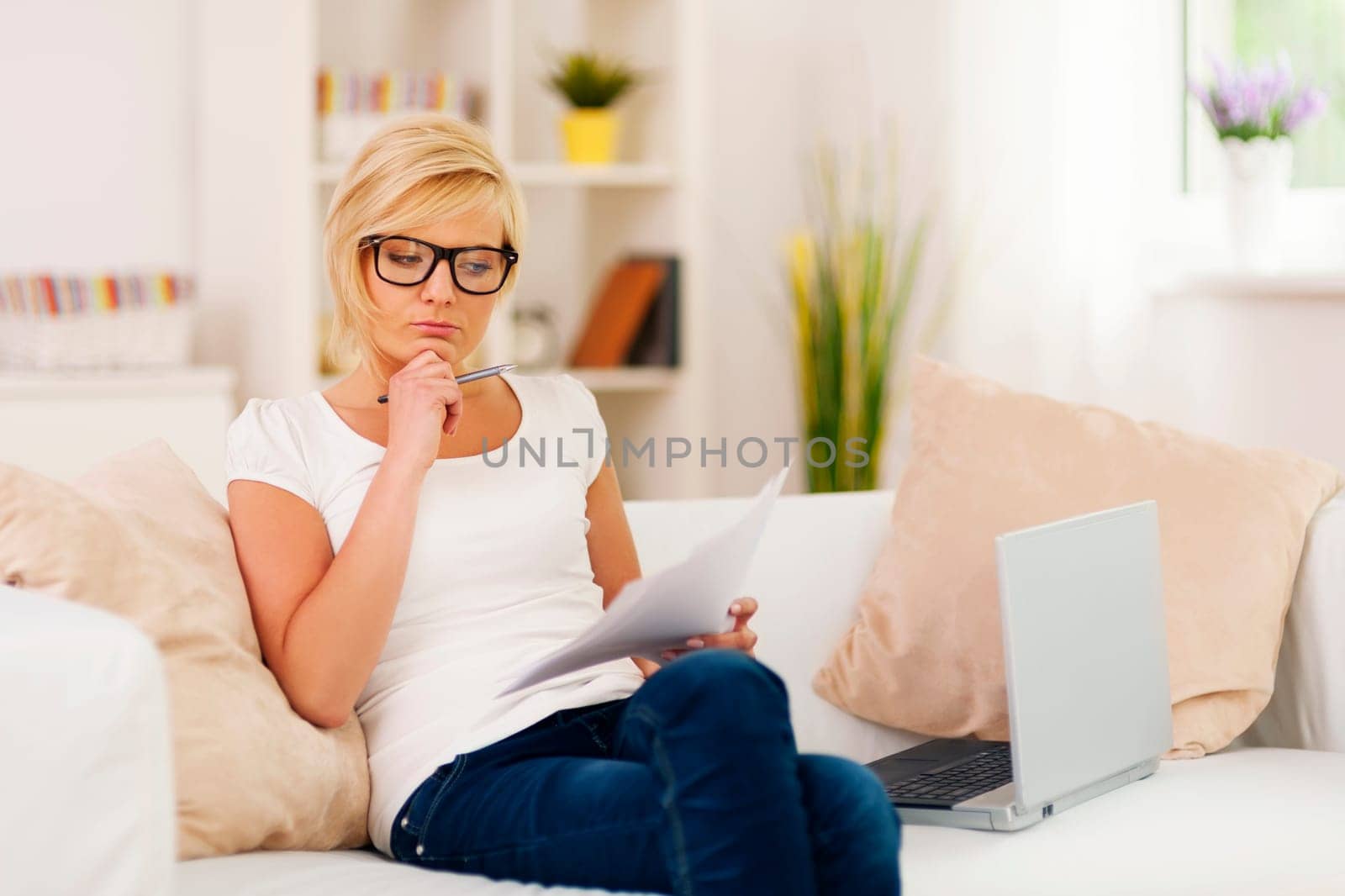 Pensive woman working at home